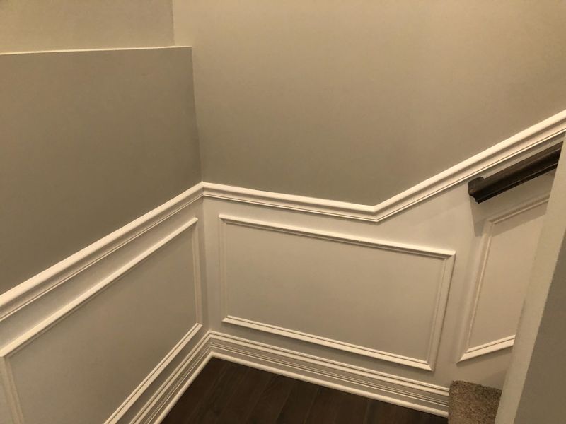 Stairway with white wainscoting