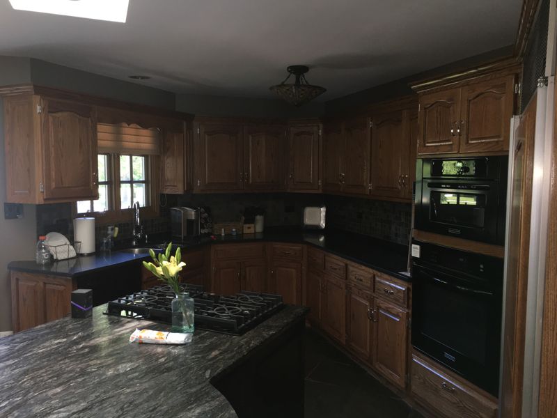 Before: dark wood kitchen cabinets